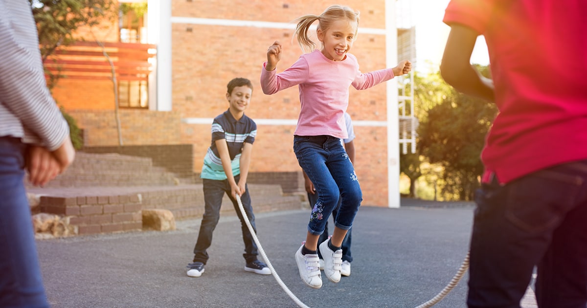 Kids playing jump rope during recess.